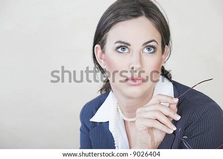 Portrait of successful brunette business woman with natural make-up wearing pinstripe suit