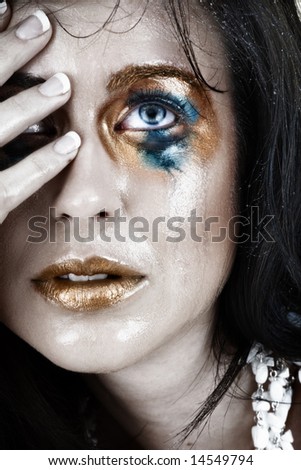 young woman with smudged make-up and face wet from tears with very upset expression
