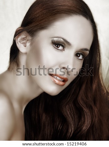 beautiful woman with long brown hair and long false lashes