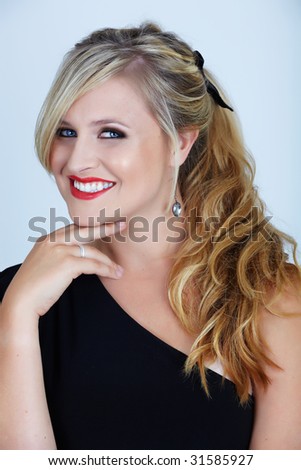 young woman woth smoky bue eyes and long blond hair in off-shoulder black party dress