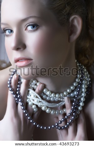beautiful woman with blue eyes in pearl necklace