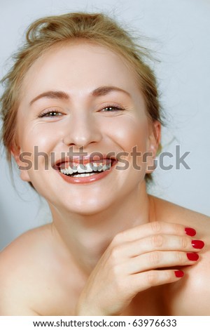 laughing beautiful young woman with fine laugh lines around her eyes.