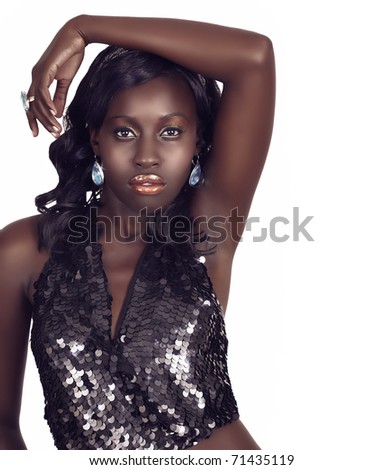 beautiful African American woman with bright gold fashion make-up and long curly hair wearing metallic sequin top with copy space over white.