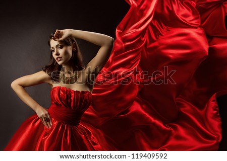 Woman in red dress dancing with flying fabric, Fashion Model Girl Posing with waving cloth