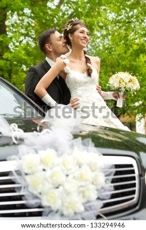 Bride and groom hugging and kissing outside. Wedding couple portrait