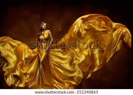 Woman Gold Dress, Lady In Fluttering Silk Gown, Fashion Beauty Model, Fabric Waving On Wind, Beautiful Girl With Long Dynamic Flying Cloth