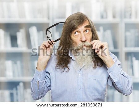 Thoughtful Senior with Glasses Thinking Inspired Looking up. Pensive Old Man with Beard over book library