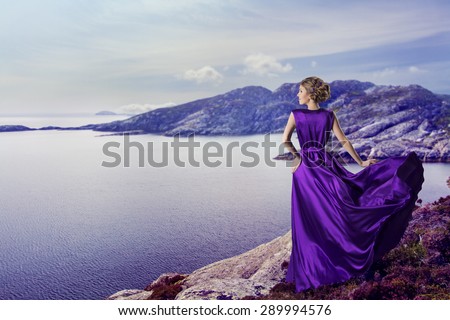 Woman in Purple Dress Looking to Mountains Sea, Waving Gown Flying on Wind, Elegant Girl Waiting on Coast