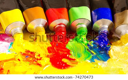 Multicolored tubes of paint. Several colors on palette.