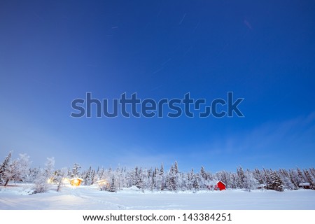 Star Trail Winter landscape with cabin hut at night in Kiruna Sweden at Night