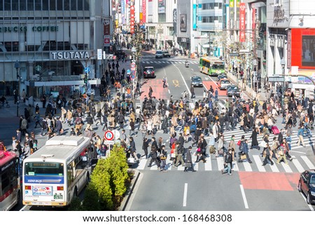 TOKYO - DECEMBER 11: Pedestrians cross at Shibuya Crossing December 11, 2013 in Tokyo, Japan. The crosswalk is one of the world\'s most famous implementations of a scramble crosswalk.