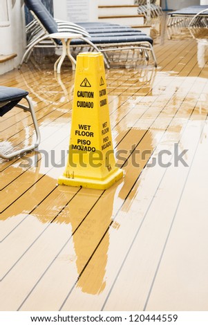 Warning Cone on wet wooden ships deck