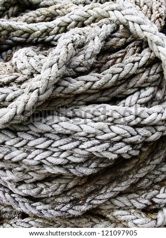 A large coil of old frayed rope