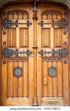 A set of old custom wood doors with brass hinges and inserts