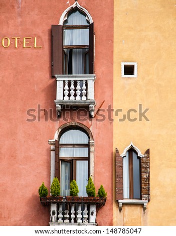 Two balconies on colorful old hotel in Venice, Italy