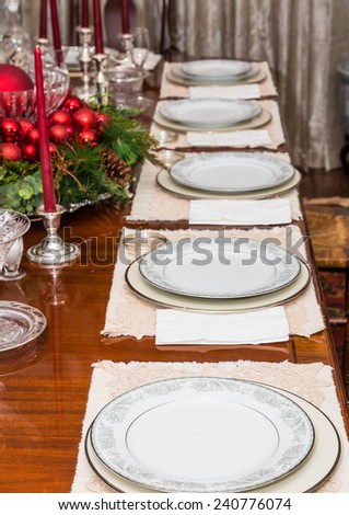 An elegant dining room table decorated for a Christmas dinner
