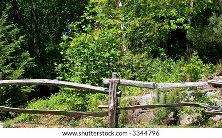 An old split rail fence of timbers in the woods