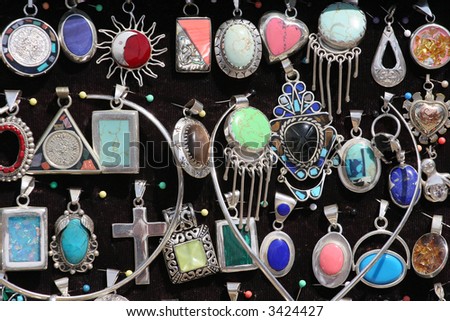 A array of colorful silver pendants at a market