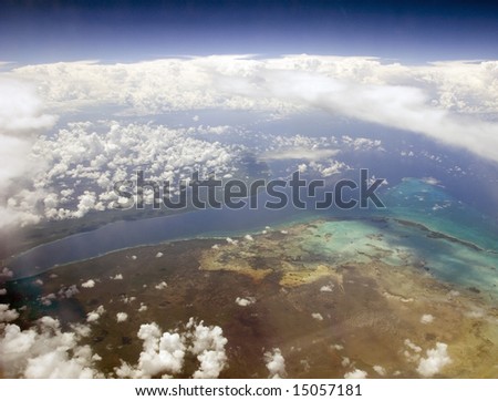 Tropical Land and Ocean through the clouds from above
