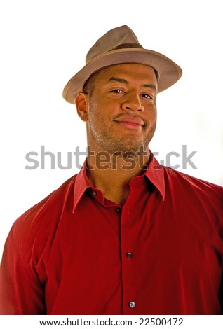 A black man in a red shirt and an old brown hat with a smile or smirk