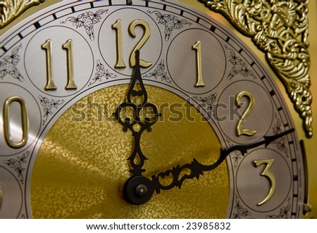 Face of an old grandfather clock showing twelve-twelve