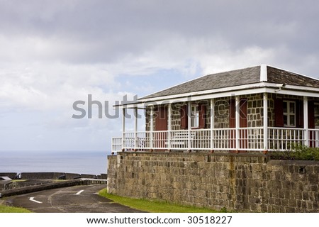 An old stone building high above the sea