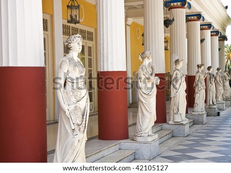 Statues and columns outside an ancient Greek palace