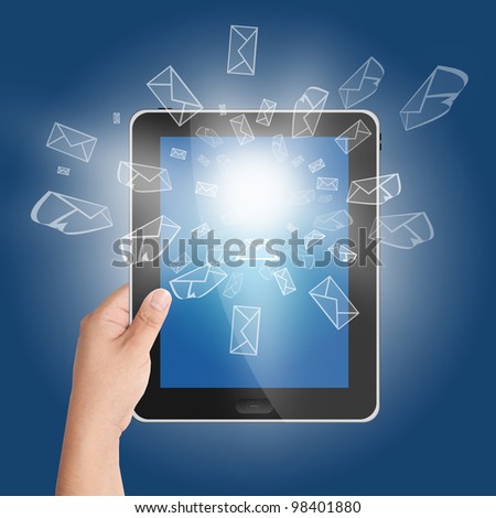Hand holding tablet PC with 3D mail icon coming from the screen on blue background