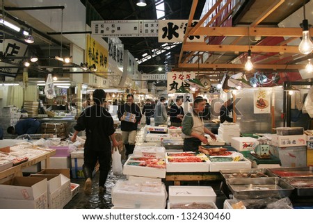 TOKYO - APRIL 13 : Fish seller at Tsukiji Market, the biggest wholesale market in Japan, market will be moved to new location in 2014, April 13, 2006 in Tokyo, Japan.