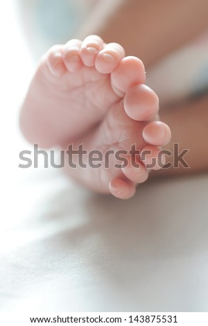 infant baby feet in natural lighting