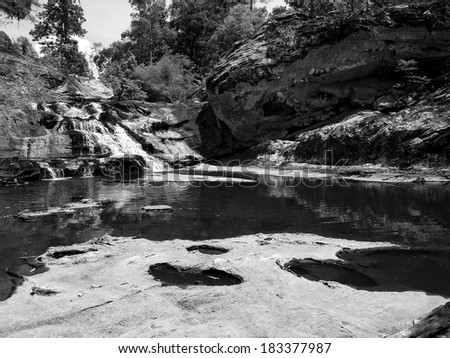 Waterfall and mountain rock in forest, monotone black and white color