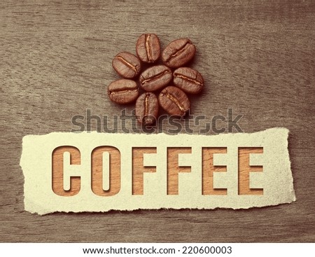 Coffee crop beans with paper and text on wood texture, vintage color background