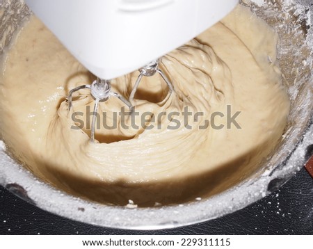 Mixing egg, banana, cake flour in bowl with motor mixer, baking banana cake