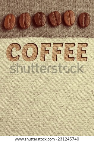 Roasted Coffee crop beans on fabric textile, vintage color background