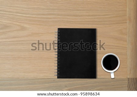 black book on table with coffee