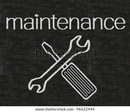 maintenance written on blackboard with tool sign