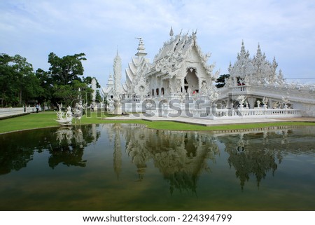 Chiangrai ,Thailand -July 5, 2014 : Wat Rong Khun more well-known as the White Temple, the tip of a main structure at Wat Rong Khun was damaged after the quake since may , 2014, now wait for repair.