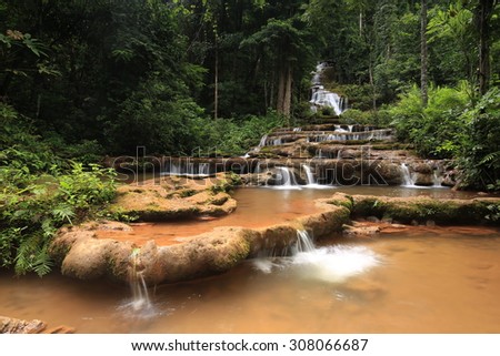 Paradise waterfall in Tropical rain forest of Thailand , water fall in deep forest at border of Chaing rai and phayao province Thailand . The waterfall named Pha Charoen waterfall