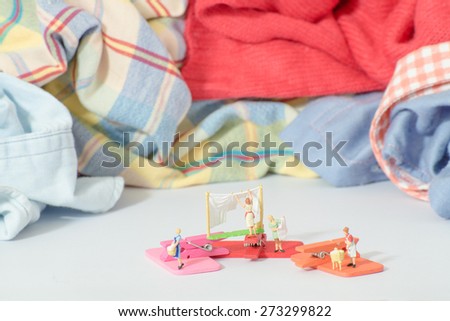 Miniature figure of woman doing laundry concept