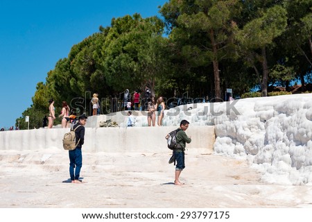PAMUKKALE, TURKEY- APRIL,12: Tourists on Pamukkale travertines on April 12, 2015 in Pamukkale, Turkey. Pamukkale, UNESCO world heritage site, nowadays become one of the most visited sights in Turkey.