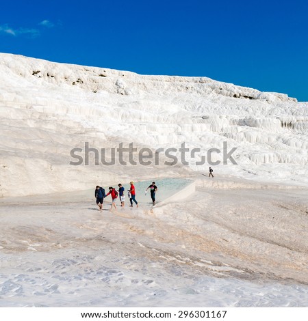 PAMUKKALE, TURKEY- APRIL,12: Tourists on Pamukkale travertines on April 12, 2015 in Pamukkale, Turkey. Pamukkale, UNESCO world heritage site, nowadays become one of the most visited sights in Turkey