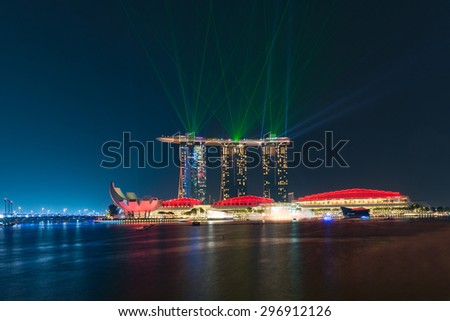 SINGAPORE - JULY 09: laser show at the Marina Bay Sands on July 09, 2015 in Singapore. Marina Bay Sands is an integrated resort and the world\'s most expensive standalone casino property at S$8 billion