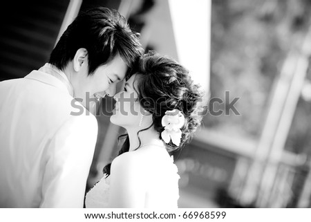 romantic bride and groom, each other seeing eyes in black and white