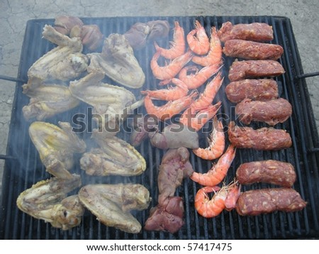 Cooking on the barbeque - shrimps, raw meat, chicken wings, chicken livers/ Barbeque