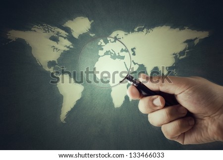 magnifying glass in hand for watch the world