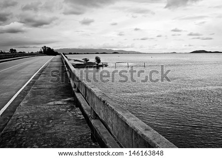 black and white bridge over the sea