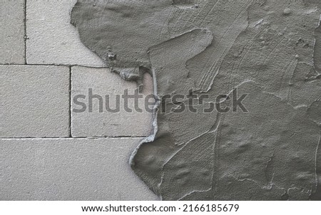 Cement mortar mixed to bond building blocks and coating lightweight concrete wall surface. Plaster texture layer. Building construction. Foto stock © 