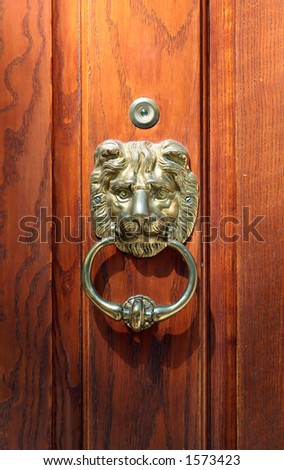 Oak door with brass lion head knocker.