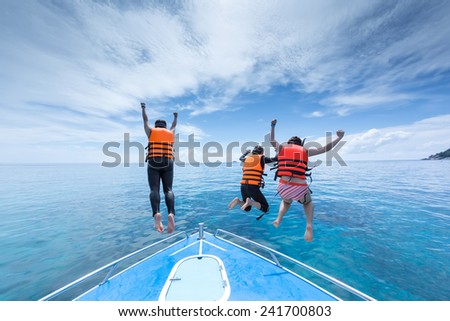 tree people is jumping from speed boat at Ta-chi, Similan Island, Thailand with happiness