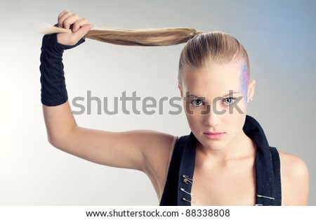 Attractive fashion model with long blonde hair and a lash on light background